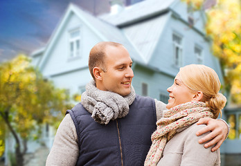 Image showing happy couple over living house in autumn
