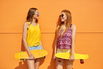 Image showing teenage girls with short skateboards outdoors