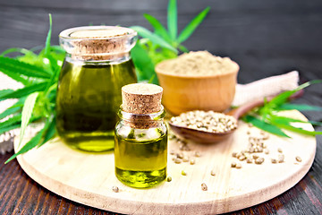 Image showing Oil hemp in two jars with flour on board