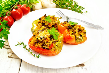 Image showing Pepper stuffed with mushrooms and couscous in white plate on tab