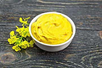 Image showing Sauce mustard in bowl with flower on black board