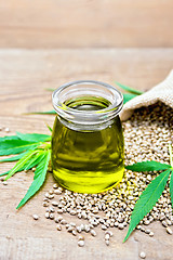 Image showing Oil hemp in jar with sheet on board