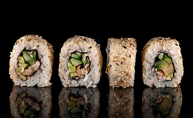 Image showing Several sushi california rolls in a row