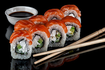 Image showing Philadelphia sushi rolls with chopsticks
