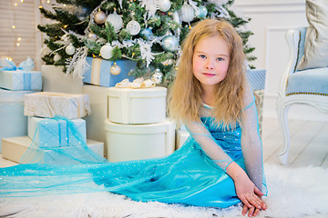 Image showing Cute girl sitting near Christmas Tree