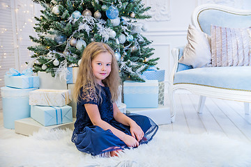 Image showing Cute girl sitting near Christmas Tree