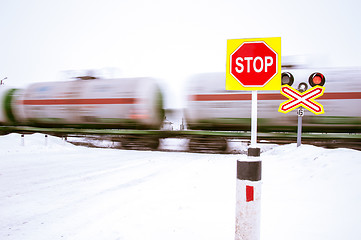 Image showing A stop sign at a railroad crossing.