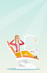 Image showing Afraid woman sitting in the dental chair.