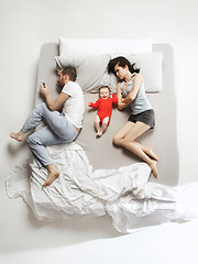 Image showing Top view of happy family with one newborn child in bedroom.