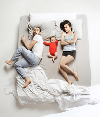 Image showing Top view of happy family with one newborn child in bedroom.