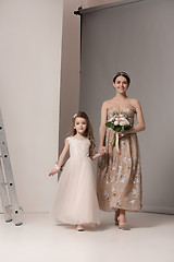 Image showing Little pretty girls with flowers dressed in wedding dresses