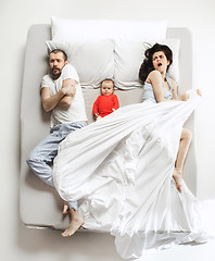 Image showing Top view of happy family with one newborn child in bedroom.