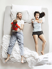 Image showing Top view of happy family with one newborn child in bedroom.