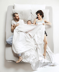 Image showing Top view of happy family with one newborn child in bedroom.