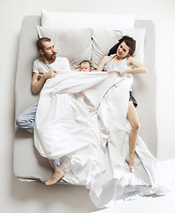 Image showing Top view of happy family with one newborn child in bedroom.