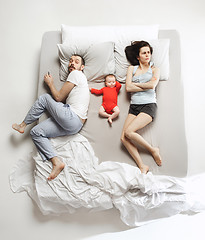 Image showing Top view of happy family with one newborn child in bedroom.