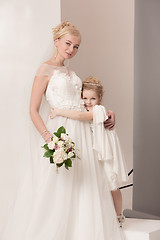 Image showing Little pretty girls with flowers dressed in wedding dresses