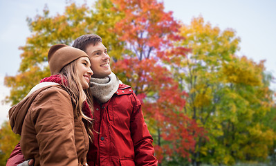 Image showing happy teenage couple hugging in autumn park