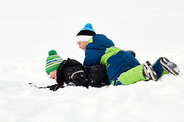 Image showing happy little boys playing outdoors in winter