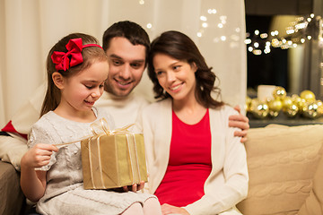 Image showing happy family with christmas present at home