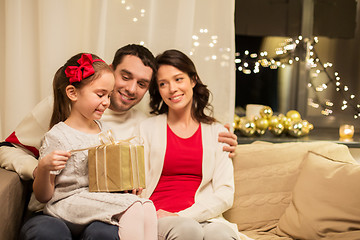 Image showing happy family with christmas present at home