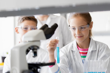 Image showing teacher and students studying chemistry at school