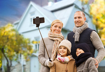 Image showing family takes autumn selfie by cellphone over house