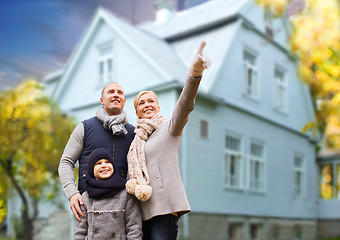 Image showing happy family over living house in autumn