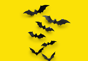 Image showing black halloween bats on yellow background