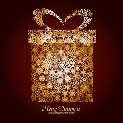 Image showing Christmas card with gift box made from gold snowflakes on brown backgroun