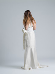 Image showing Rear view of a beautiful young woman in a wedding dress