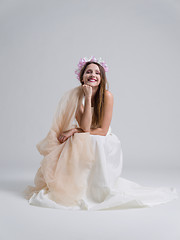 Image showing young bride sitting in a wedding dress