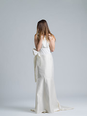 Image showing Rear view of a beautiful young woman in a wedding dress