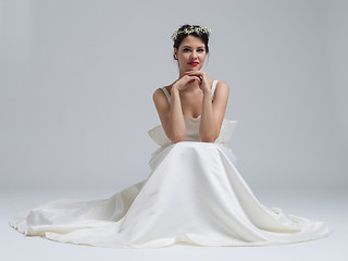 Image showing young bride sitting in a wedding dress