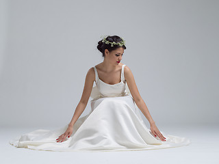 Image showing young bride sitting in a wedding dress