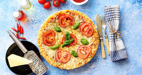 Image showing Delicious italian pizza served on blue stone table, shot from above