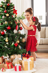 Image showing happy family decorating christmas tree at home