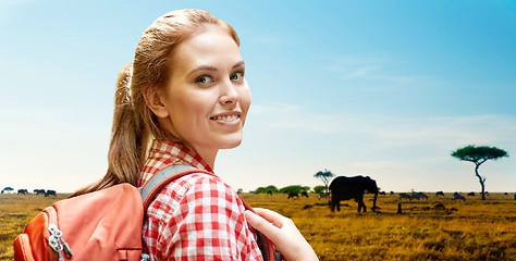 Image showing happy woman with backpack over african savannah