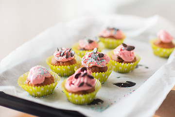 Image showing close up of frosted cupcakes or muffins on tray