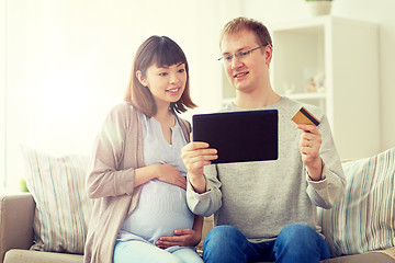 Image showing husband and pregnant wife shopping online at home