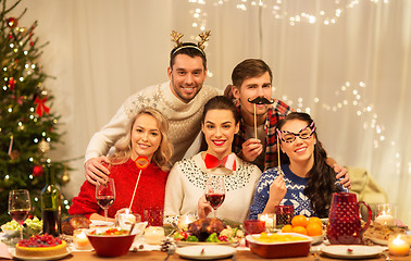 Image showing happy friends celebrating christmas at home