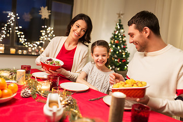 Image showing happy family having christmas dinner at home