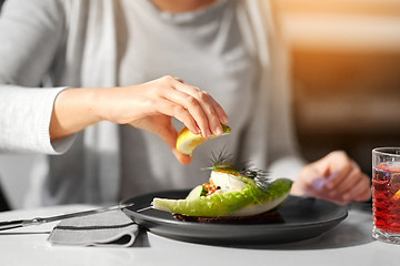 Image showing woman eating caviar salad at cafe or restaurant