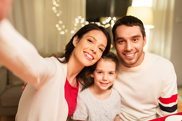 Image showing happy family taking selfie at christmas