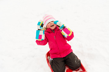 Image showing happy little girl on sled outdoors in winter