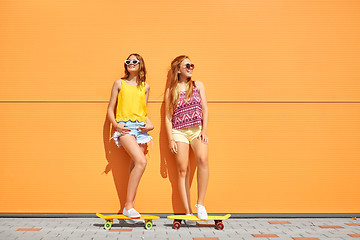 Image showing teenage girls with short skateboards outdoors