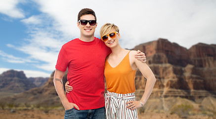 Image showing couple in sunglasses hugging