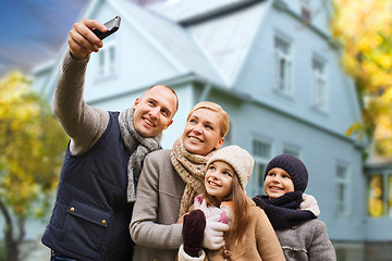 Image showing family takes autumn selfie by cellphone over house