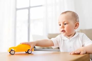 Image showing baby boy playing with toy car at home