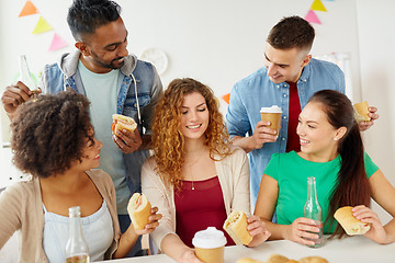 Image showing happy friends or team eating at office party